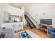 Stylish living space featuring a modern staircase, breakfast bar, and a cozy seating area with a TV at 115 E Park Ave # 409, Charlotte, NC 28203
