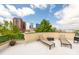 Relax on the roof deck featuring lounge chairs and city views at 115 E Park Ave # 409, Charlotte, NC 28203