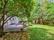Secluded backyard with a deck, lush greenery, and a storage shed providing a private outdoor retreat at 1219 Pinecrest Ave, Charlotte, NC 28205