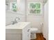 Charming bathroom featuring white wainscoting, chrome fixtures, and natural light at 1219 Pinecrest Ave, Charlotte, NC 28205