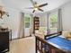 Cozy bedroom featuring a ceiling fan, large windows, and a comfortable armchair at 1219 Pinecrest Ave, Charlotte, NC 28205