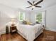 Bright bedroom with hardwood floors, ceiling fan, and natural light from two windows at 1219 Pinecrest Ave, Charlotte, NC 28205