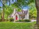 Charming home with a bright red door, lush landscaping, and a well-manicured lawn at 1219 Pinecrest Ave, Charlotte, NC 28205