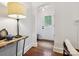 Bright foyer featuring hardwood floors and a marble topped table with lamp as you enter at 1219 Pinecrest Ave, Charlotte, NC 28205