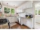 Well-lit kitchen featuring granite countertops, white cabinets, and stainless steel appliances at 1219 Pinecrest Ave, Charlotte, NC 28205