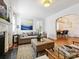 Bright living room with fireplace, neutral furniture, and view into the dining room at 1219 Pinecrest Ave, Charlotte, NC 28205