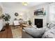 Cozy living room with a white fireplace, hardwood floors, and comfortable seating at 1219 Pinecrest Ave, Charlotte, NC 28205