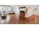 Cozy living room featuring a fireplace, light colored walls, hardwood floors, and a wooden rocking chair at 1219 Pinecrest Ave, Charlotte, NC 28205