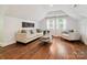 Living Room boasts a plush sofa and chairs, natural light, and hardwood floors at 1219 Pinecrest Ave, Charlotte, NC 28205