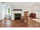 Living Room features a fireplace, wooden rocking chair, light colored walls, and hardwood floors at 1219 Pinecrest Ave, Charlotte, NC 28205
