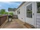Outdoor porch featuring a grill, wooden deck, and a door leading to the home's interior at 123 N Poston St, Shelby, NC 28150