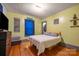 Inviting bedroom with hardwood floors, vibrant walls, and art, creating a comfortable and expressive space at 123 N Poston St, Shelby, NC 28150