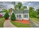 Charming single-story home with a green roof, small front porch, and meticulous landscaping at 123 N Poston St, Shelby, NC 28150