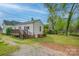Lovely home exterior with a deck, green grass, and mature trees, perfect for outdoor living and relaxation at 123 N Poston St, Shelby, NC 28150