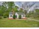 Charming home with a brick chimney, green roof, and a well-manicured front yard at 123 N Poston St, Shelby, NC 28150