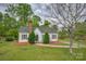 Charming home with a brick chimney, green roof, and a well-manicured front yard at 123 N Poston St, Shelby, NC 28150