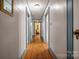 Hallway featuring hardwood floors, light-colored walls, and blue-trimmed doorways for a charming, classic appeal at 123 N Poston St, Shelby, NC 28150