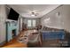 Living room featuring a decorative fireplace, large sectional sofa, and hardwood flooring at 123 N Poston St, Shelby, NC 28150