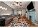 Cozy living room featuring a decorative fireplace, large sectional sofa, and hardwood flooring at 123 N Poston St, Shelby, NC 28150