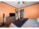 Comfortable main bedroom with hardwood flooring, orange painted walls, and gray trim for a touch of uniqueness at 123 N Poston St, Shelby, NC 28150