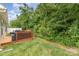 A lovely backyard featuring a wooden deck, lush green grass, and serene landscaping at 1405 Amberlight Cir, Salisbury, NC 28144