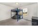 Bedroom features a blue loft bed, beanbag chair, and window view at 1405 Amberlight Cir, Salisbury, NC 28144