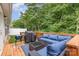 Outdoor deck area features comfortable blue seating and lush greenery in the background at 1405 Amberlight Cir, Salisbury, NC 28144