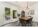 Cozy dining area with a wooden table, stylish chairs, modern lighting, and access to a patio at 1405 Amberlight Cir, Salisbury, NC 28144