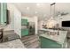 Modern kitchen featuring a granite island, stainless steel appliances, and stylish green cabinetry at 1405 Amberlight Cir, Salisbury, NC 28144