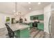 Open kitchen layout with a granite island, stainless steel appliances, and modern pendant lighting at 1405 Amberlight Cir, Salisbury, NC 28144