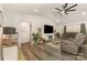 Bright living room featuring gray sofas, vaulted ceiling, modern fan, and stylish décor at 1405 Amberlight Cir, Salisbury, NC 28144