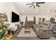 Comfortable living room showcasing gray sofas, large TV, and decorative ladder shelving at 1405 Amberlight Cir, Salisbury, NC 28144