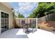 Cozy backyard patio includes outdoor seating, a small table, and a privacy fence at 14218 Springsure Ct, Huntersville, NC 28078