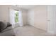 Bright bedroom with large window, allowing natural light, neutral paint, and double door closet at 14218 Springsure Ct, Huntersville, NC 28078