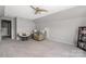 Spacious bonus room featuring a cozy chair, neutral paint, and a ceiling fan at 14218 Springsure Ct, Huntersville, NC 28078