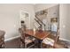 Formal dining area featuring hardwood floors, neutral tones, and staircase access at 14218 Springsure Ct, Huntersville, NC 28078