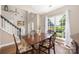 Dining room with hardwood floors, large windows providing natural light, and staircase access at 14218 Springsure Ct, Huntersville, NC 28078