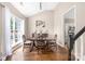 Bright dining area with hardwood floors, a large window, and staircase in view at 14218 Springsure Ct, Huntersville, NC 28078