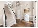 Grand two-story entryway with a staircase, hardwood floors, and stylish decor at 14218 Springsure Ct, Huntersville, NC 28078