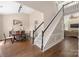 Open-concept entryway with wood floors, carpeted stairs, and dining area with beautiful natural light at 14218 Springsure Ct, Huntersville, NC 28078