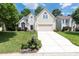 Charming two-story home with a manicured lawn, blossoming flowerbeds, and a driveway leading to a two-car garage at 14218 Springsure Ct, Huntersville, NC 28078