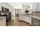 Functional kitchen offering tile countertops, cabinetry, and open access to the dining area at 14218 Springsure Ct, Huntersville, NC 28078