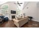 Spacious living room featuring high ceilings, a fireplace, and hardwood flooring at 14218 Springsure Ct, Huntersville, NC 28078