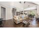 Inviting living room featuring hardwood floors and an open floor plan leading to the kitchen and staircase at 14218 Springsure Ct, Huntersville, NC 28078