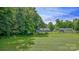 Expansive backyard with lush green grass, mature trees, and home in the background at 1435 W Ridge Rd, Salisbury, NC 28147