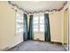 Bedroom featuring three large windows and blue curtains at 1435 W Ridge Rd, Salisbury, NC 28147