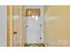Front door with a window and a curtain in the entryway with tan walls at 1435 W Ridge Rd, Salisbury, NC 28147
