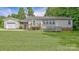 Back exterior view of home with deck and attached garage, with large manicured lawn at 1435 W Ridge Rd, Salisbury, NC 28147