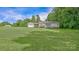 Charming ranch-style home with an attached garage, green lawn, and mature trees on a sunny day at 1435 W Ridge Rd, Salisbury, NC 28147