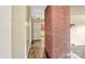 View of a hallway showcasing brick accent wall and hardwood floors at 1435 W Ridge Rd, Salisbury, NC 28147